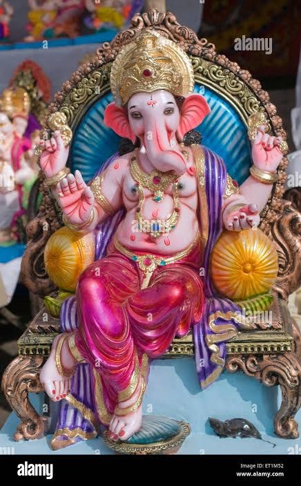 A Ganesha idol placed in a warm family home setting